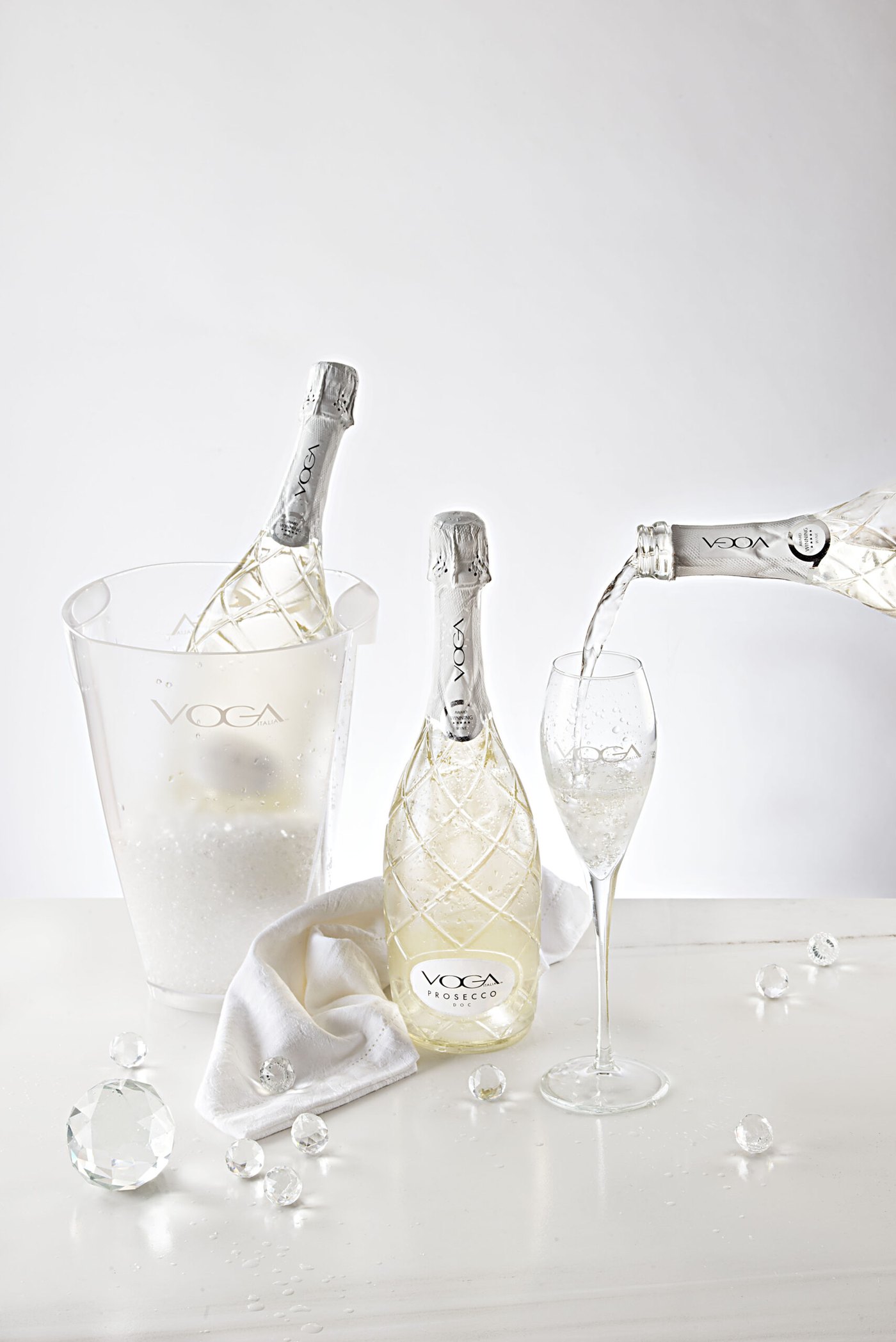 VOGA Prosecco poured into a glass beside the ice bucket